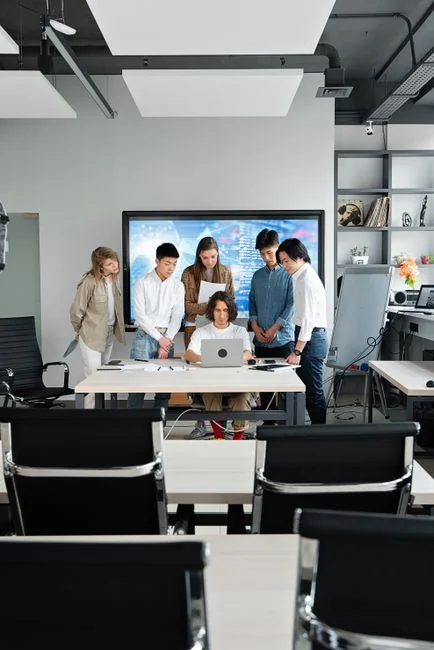 services-01 Overhead view of a diverse team collaborating on a project in a modern office setting.